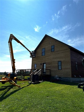 crane working on wood exterior