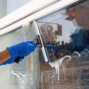 A person cleaning a window