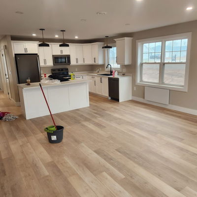 Freshly painted white kitchen with wood flooring