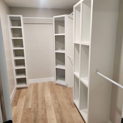 closet shelving that has been painted white with wood floor