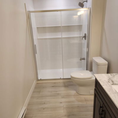 a brand new white bathroom with wood flooring