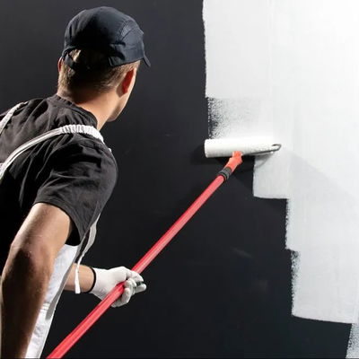 A man painting an interior wall