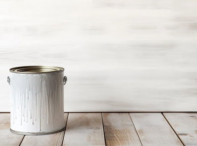 A paint bucket sitting on wood flooring