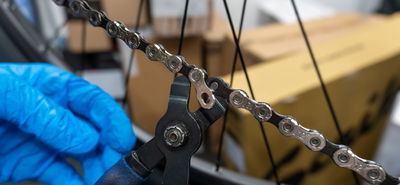 person repairing bicycle chain